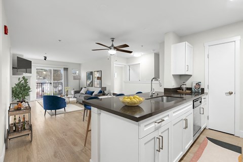a kitchen with an island and a living room with a couch